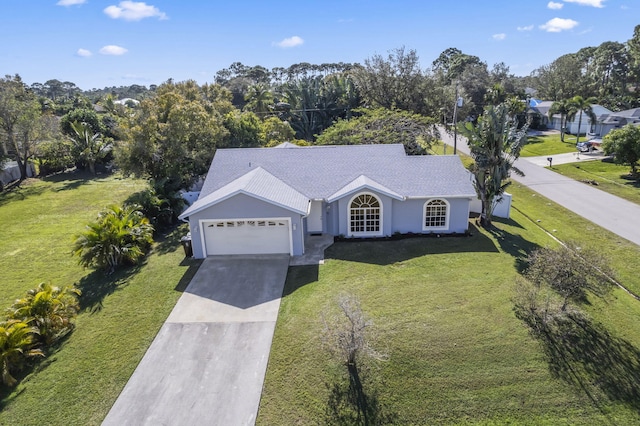 single story home with a garage and a front lawn