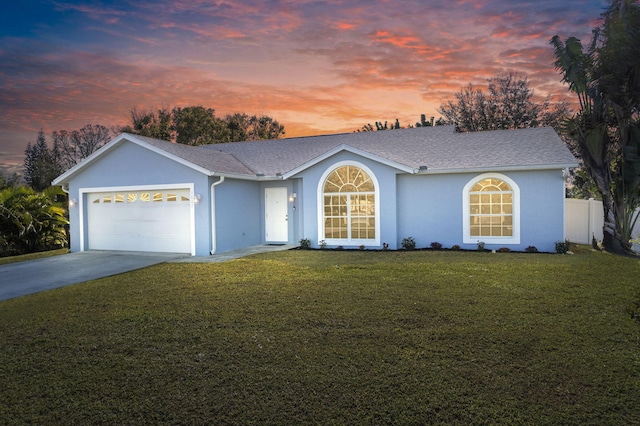 ranch-style home with a lawn and a garage