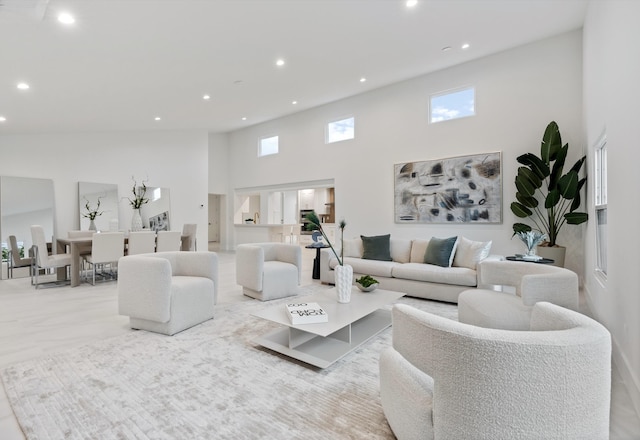 living area with a high ceiling and recessed lighting