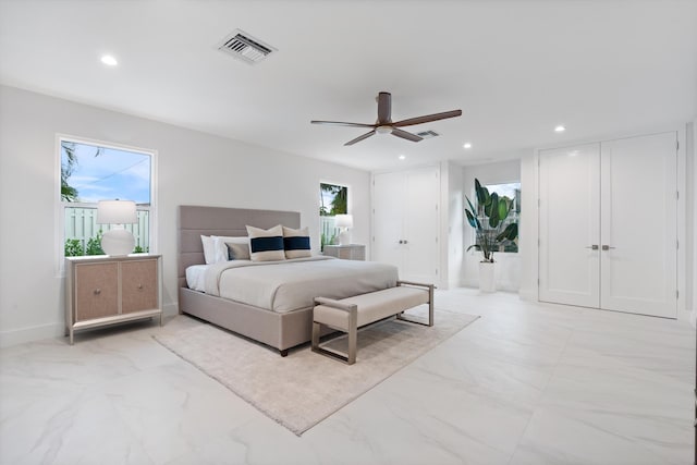 bedroom featuring multiple closets, recessed lighting, marble finish floor, and visible vents