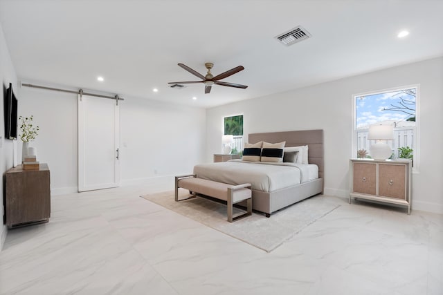 bedroom featuring marble finish floor, a barn door, multiple windows, and visible vents