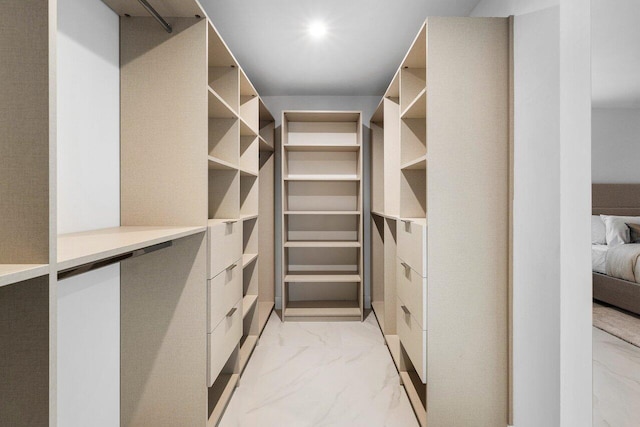 spacious closet featuring marble finish floor