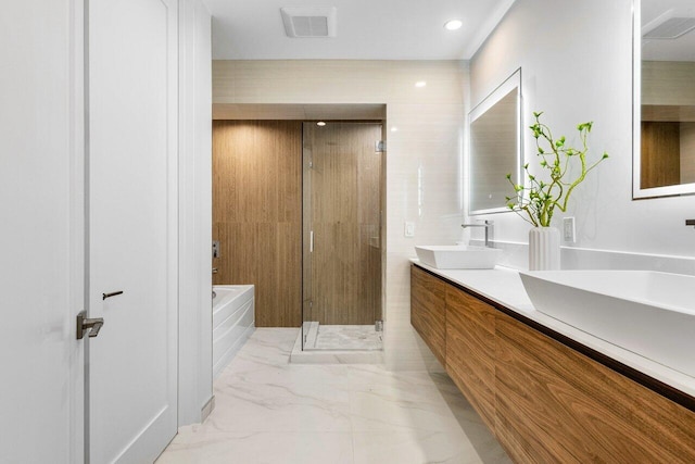 full bath with a shower stall, a bath, visible vents, marble finish floor, and a sink