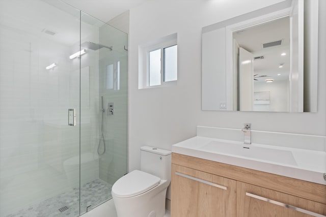 bathroom with toilet, a stall shower, visible vents, and vanity