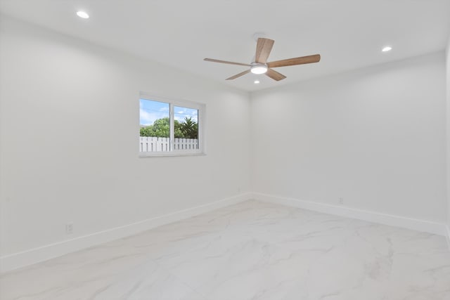 empty room featuring recessed lighting, marble finish floor, baseboards, and ceiling fan