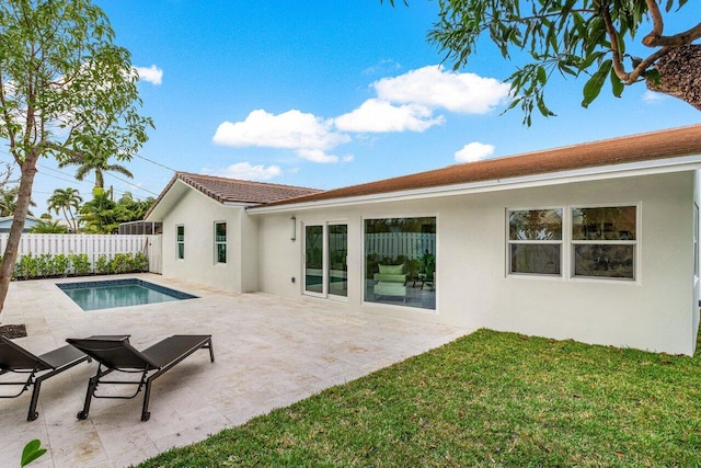 back of house with a fenced in pool, a lawn, a patio, fence, and stucco siding