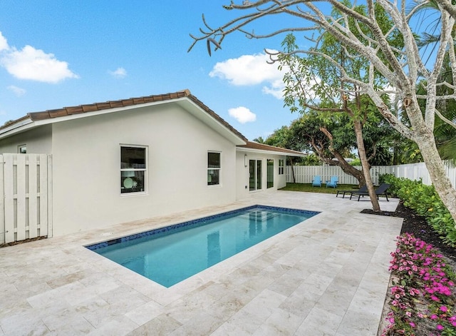 view of swimming pool featuring a fenced in pool, a patio area, and a fenced backyard