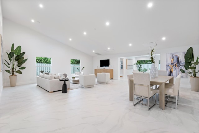 dining area with high vaulted ceiling