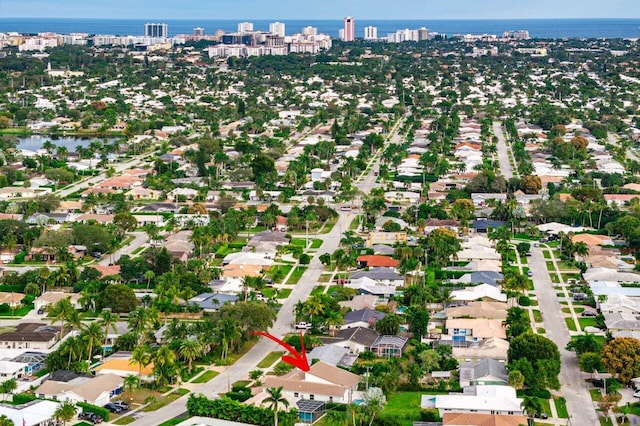 drone / aerial view with a water view and a residential view