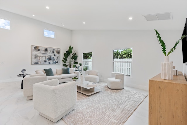 living room with recessed lighting, a towering ceiling, visible vents, and baseboards