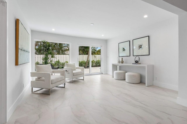 sitting room featuring marble finish floor, baseboards, and recessed lighting