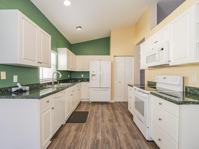 kitchen with lofted ceiling, white appliances, dark wood-type flooring, sink, and white cabinetry