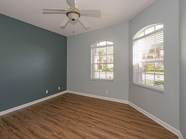 spare room with ceiling fan and dark hardwood / wood-style flooring