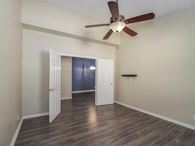 empty room featuring dark hardwood / wood-style flooring and ceiling fan