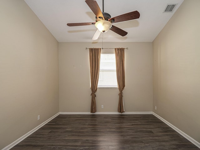 empty room featuring ceiling fan and dark wood-type flooring