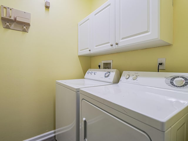 laundry area featuring cabinets and washing machine and dryer