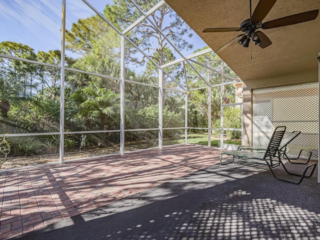 unfurnished sunroom featuring ceiling fan and lofted ceiling