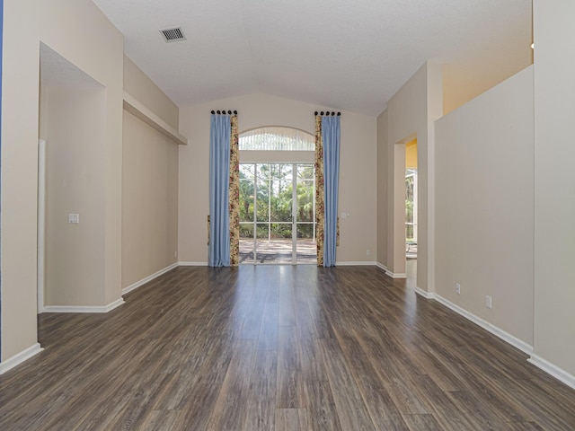 empty room featuring dark hardwood / wood-style floors and vaulted ceiling