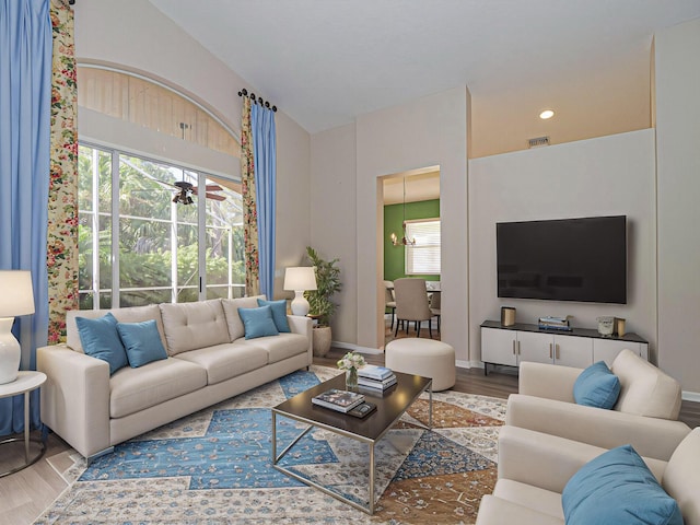 living room featuring hardwood / wood-style floors and an inviting chandelier