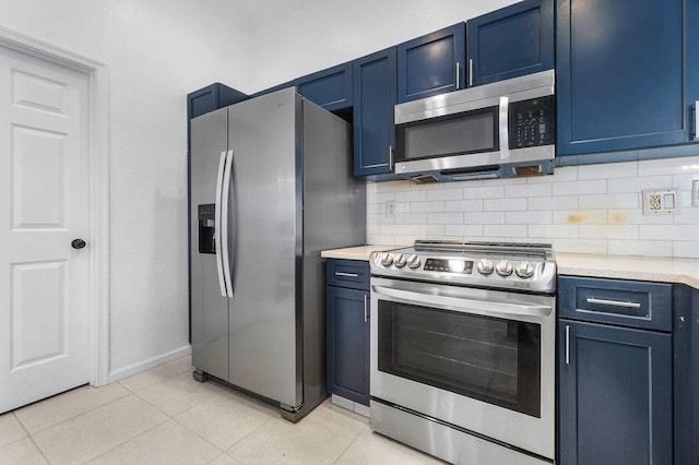 kitchen featuring backsplash, stainless steel appliances, crown molding, blue cabinetry, and light tile patterned floors