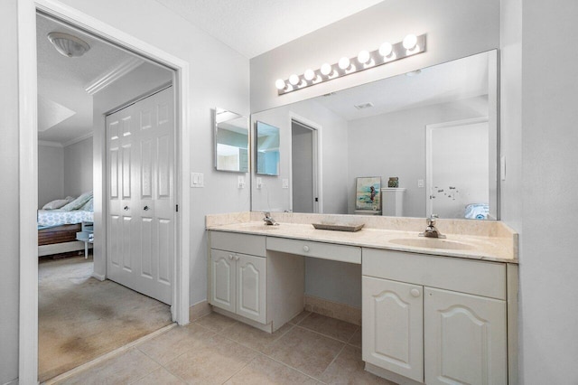 bathroom featuring tile patterned floors, crown molding, vanity, and a textured ceiling