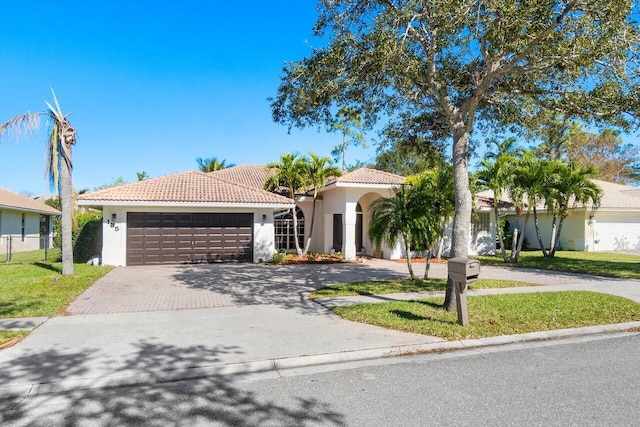 view of front of home featuring a garage and a front yard