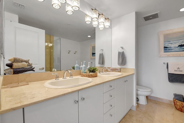 bathroom featuring toilet, vanity, tile patterned flooring, and a shower