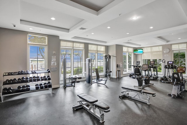 gym featuring a tray ceiling