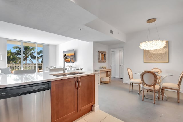 kitchen with sink, pendant lighting, stainless steel dishwasher, and a notable chandelier