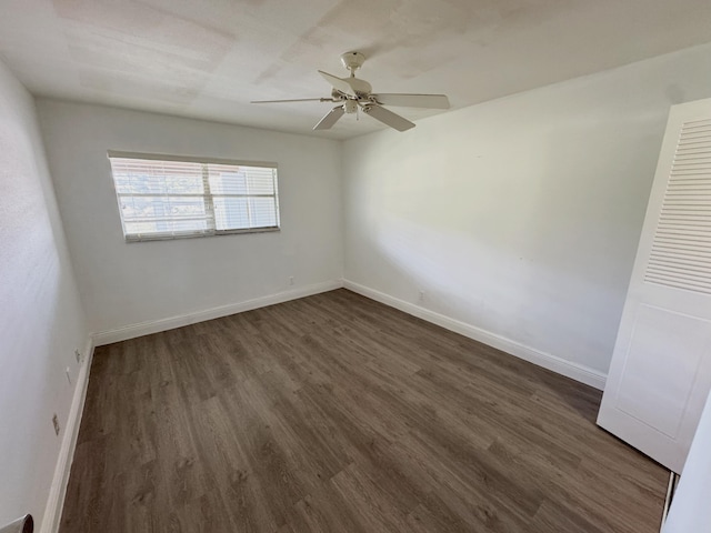 unfurnished room featuring ceiling fan and dark wood-type flooring