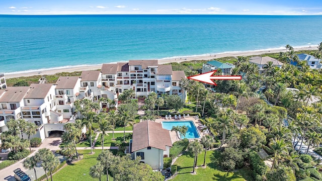 bird's eye view featuring a water view and a beach view