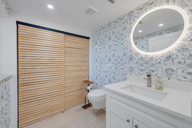 bathroom featuring vanity and toilet