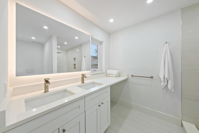 bathroom featuring vanity and a tile shower