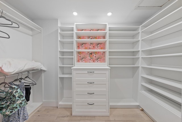 walk in closet featuring light hardwood / wood-style flooring