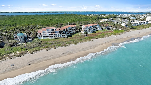 birds eye view of property with a water view and a view of the beach