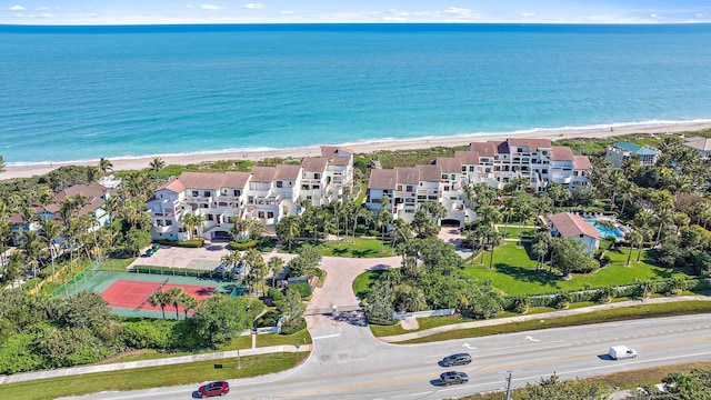 birds eye view of property with a beach view and a water view