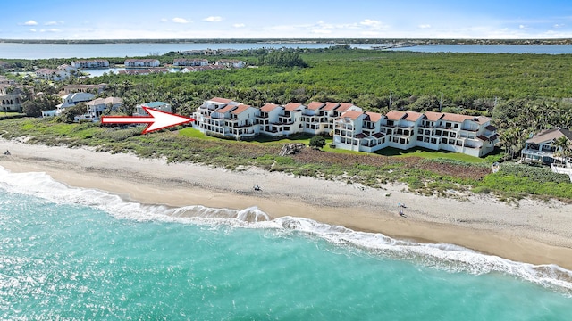 birds eye view of property with a view of the beach and a water view