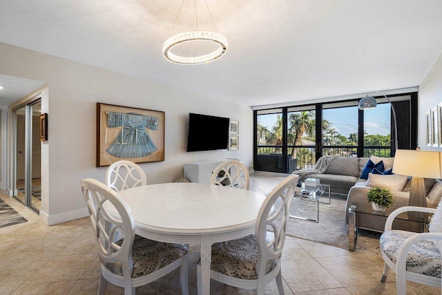 tiled dining area featuring a wall of windows