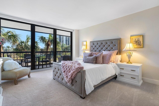 carpeted bedroom with access to exterior and floor to ceiling windows