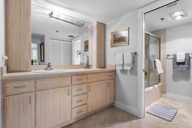 bathroom with shower / bath combination with glass door, vanity, and tile patterned floors