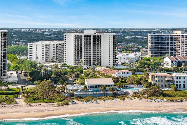 drone / aerial view featuring a beach view and a water view