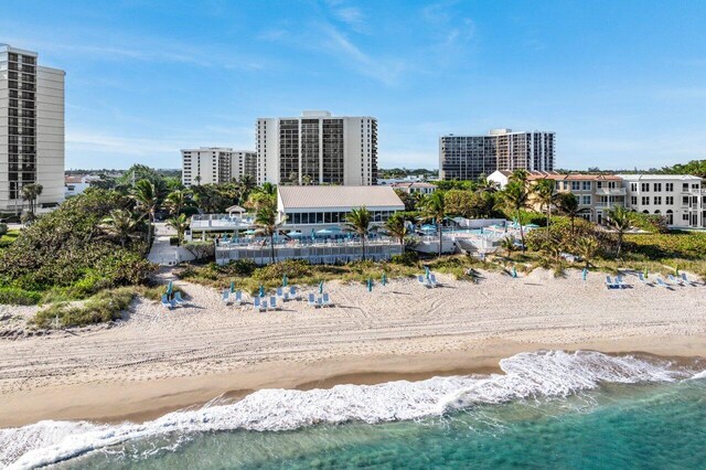 aerial view with a water view and a view of the beach