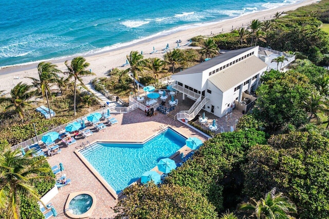 aerial view with a water view and a beach view