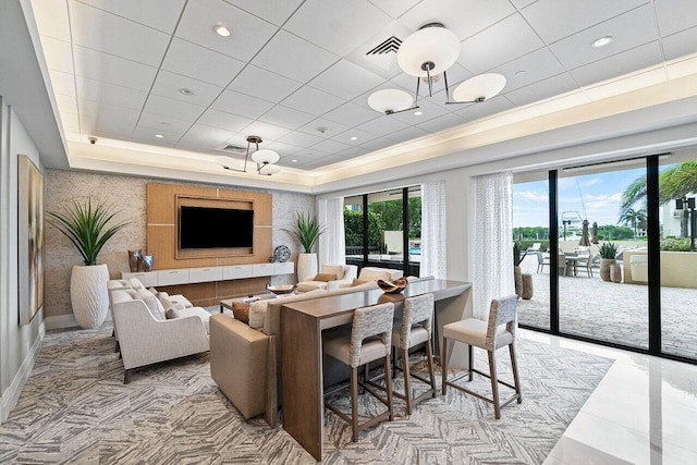 living room featuring a raised ceiling