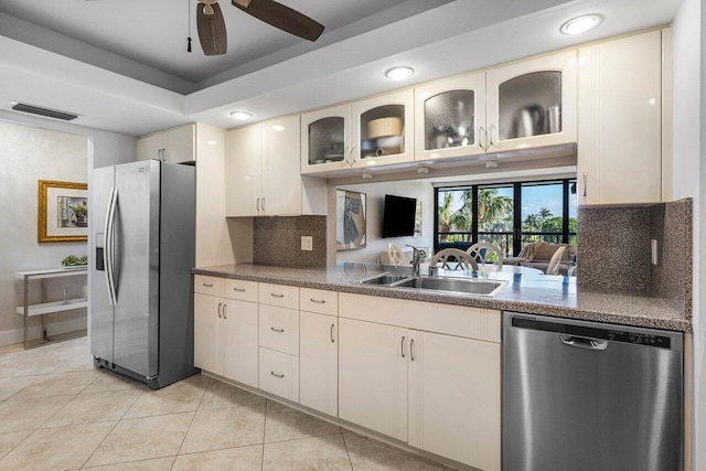 kitchen featuring tasteful backsplash, stainless steel appliances, ceiling fan, sink, and light tile patterned floors