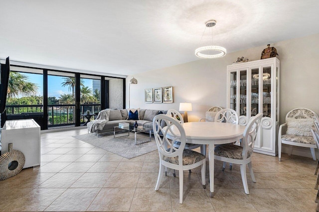 tiled dining area with floor to ceiling windows