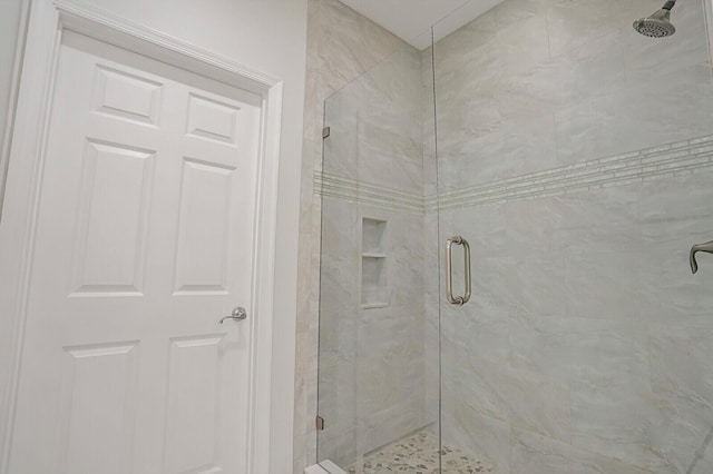 bathroom featuring a shower with shower door