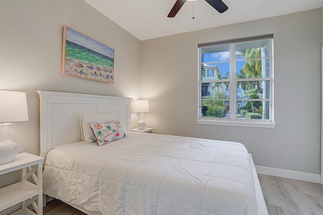 bedroom featuring multiple windows, ceiling fan, and light hardwood / wood-style flooring