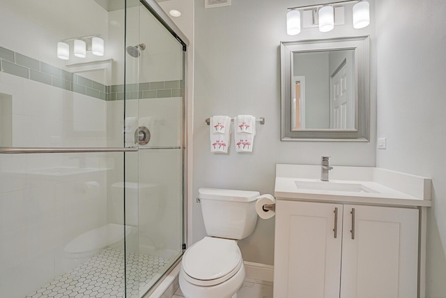 bathroom featuring an enclosed shower, vanity, toilet, and tile patterned flooring