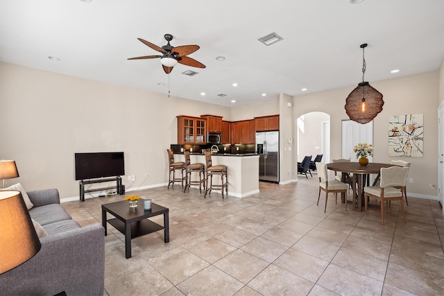 living room featuring visible vents, arched walkways, a ceiling fan, and recessed lighting